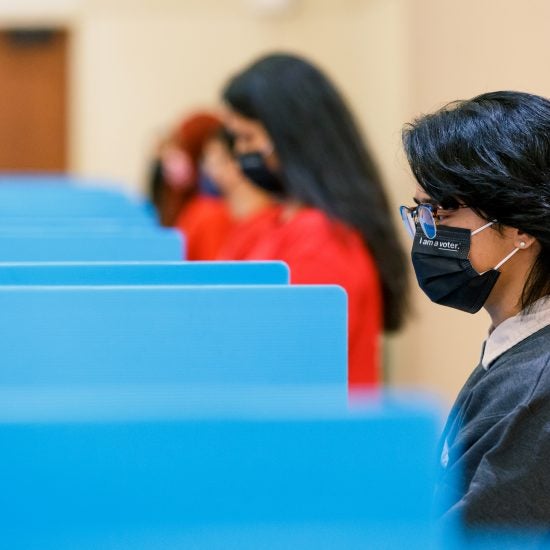 Students in voting booths wearing masks